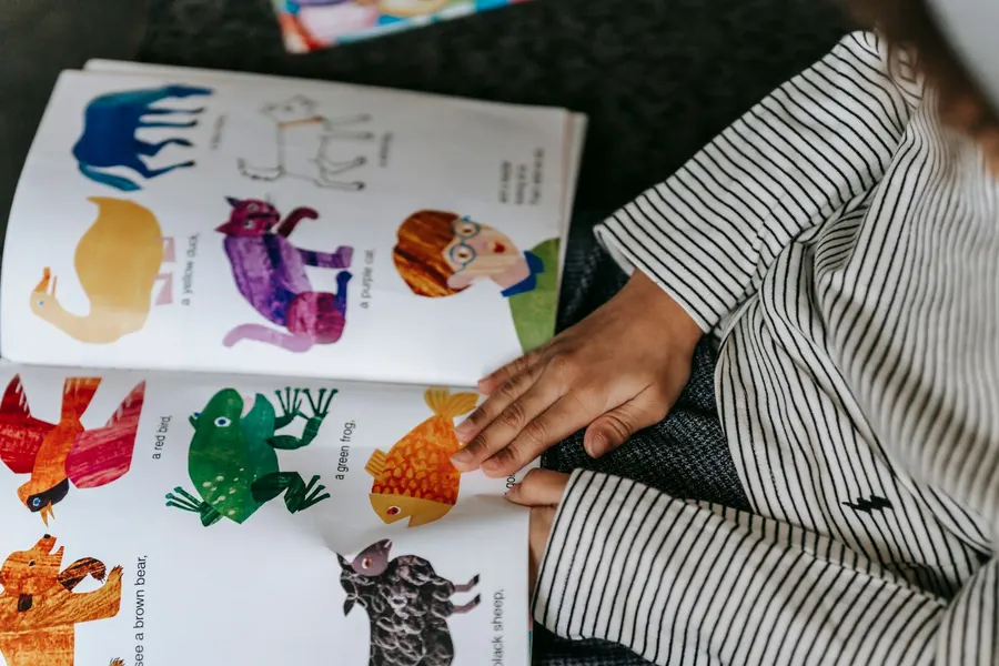 A child reading a colourful picture book